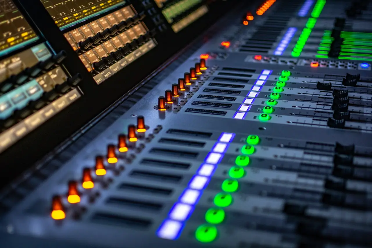 Close-up of a professional digital audio mixer with illuminated faders and buttons for live sound mixing soundcraft si impact